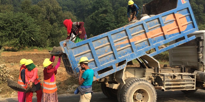 Internal migrant workers sand-sealing the road_2019.jpg